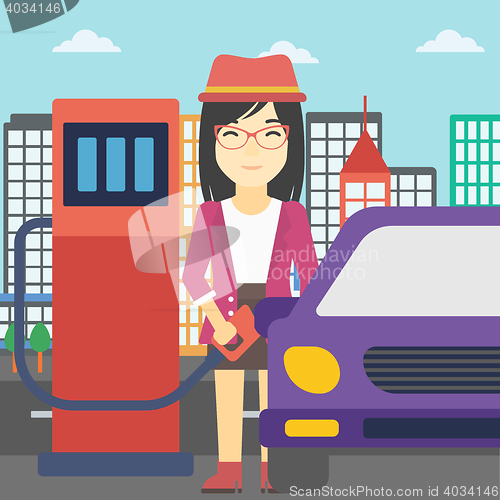 Image of Worker filling up fuel into car.