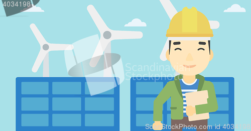 Image of Male worker of solar power plant and wind farm.