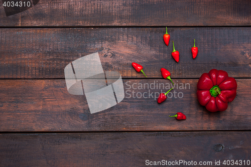 Image of fresh bitter and sweet pepper on wooden table background