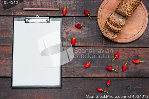 Image of Office desk table with pencils, supplies and fresh bread