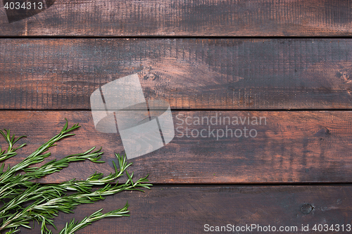 Image of Bunch of rosemary on wooden table, rustic style, fresh organic herbs, top view