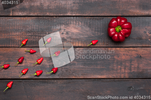 Image of fresh bitter and sweet pepper on wooden table background