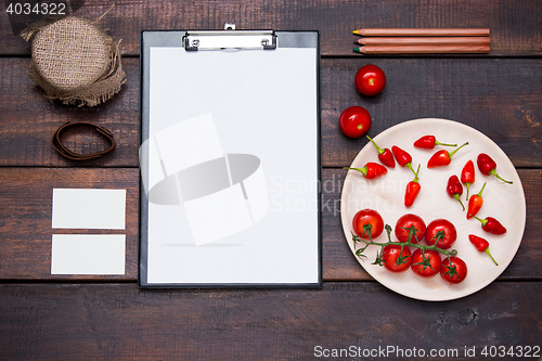 Image of Office desk table with pencils, supplies and vegetables