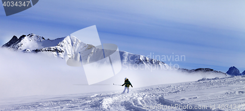 Image of Panoramic view on snowboarder downhill on off-piste slope with n