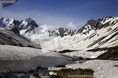 Image of River with snow bridges in spring mountains at sun morning