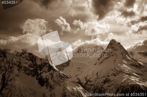 Image of Winter snow mountains in clouds