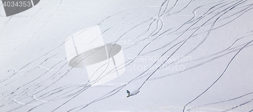 Image of Panoramic view on snowboarder downhill on off piste slope with n