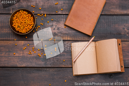 Image of Office desk table with notebooks, fresh buckthorn berries on wooden table