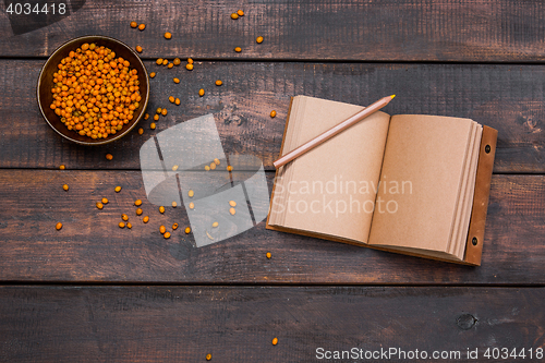 Image of Office desk table with notebooks, fresh buckthorn berries on wooden table