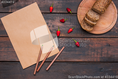 Image of Office desk table with pencils, supplies and fresh bread