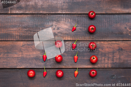Image of The cherry tomatoes, peppers, chilli on wooden table