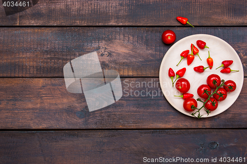 Image of The cherry tomatoes, peppers, chilli on wooden table