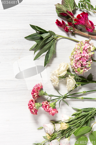 Image of The flowers on white wooden background