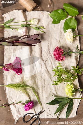 Image of The flowers on white wooden background