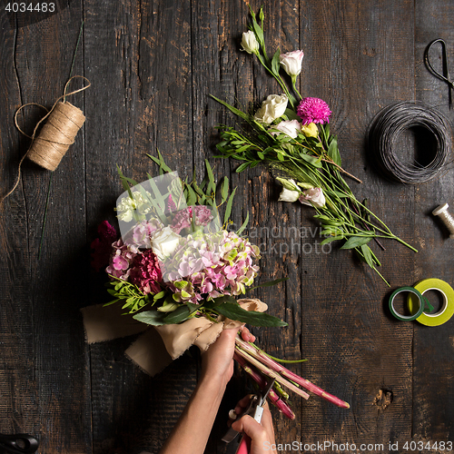 Image of The florist desktop with working tools and ribbons