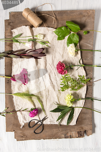 Image of The flowers on white wooden background