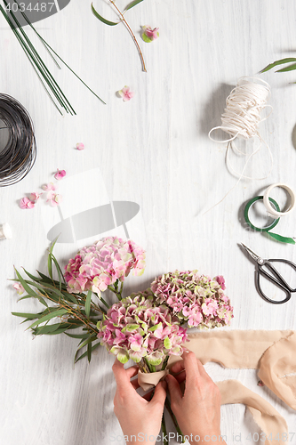 Image of The florist desktop with working tools and ribbons