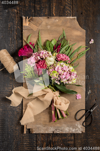 Image of The flowers on wooden background