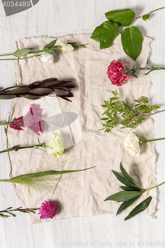 Image of The flowers on white wooden background