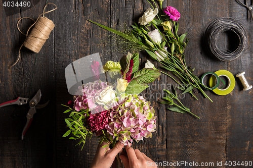 Image of The florist desktop with working tools and ribbons