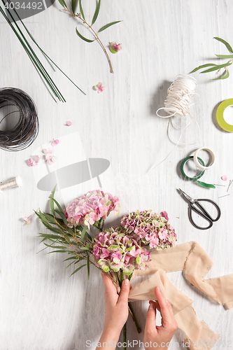 Image of The florist desktop with working tools and ribbons