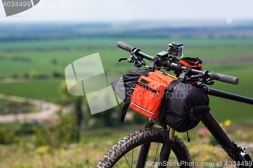 Image of Bicycle with orange bags for travel