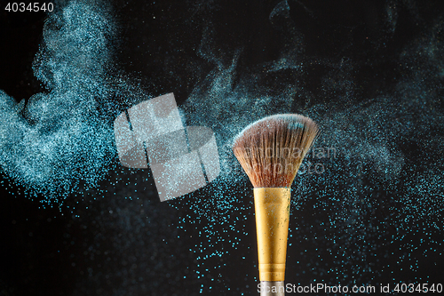 Image of Brush with blue shadows on black background