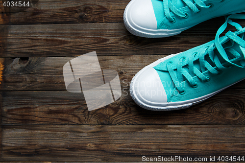 Image of blue shoes on wooden floor