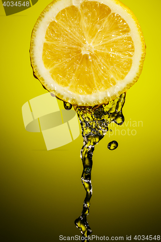 Image of Fresh water drops on lemon at yellow background