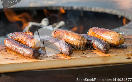 Image of Grilling sausages on barbecue grill