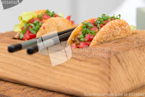 Image of fresh mexican taco shells with beef and vegetables