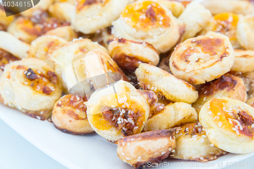 Image of cookies of puff pastry with sesame seeds