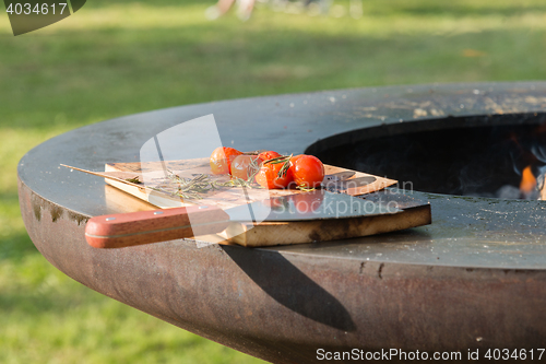 Image of tomatoes on the grill pan  the table