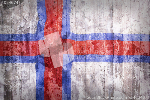Image of Grunge style of Faroe Islands flag on a brick wall
