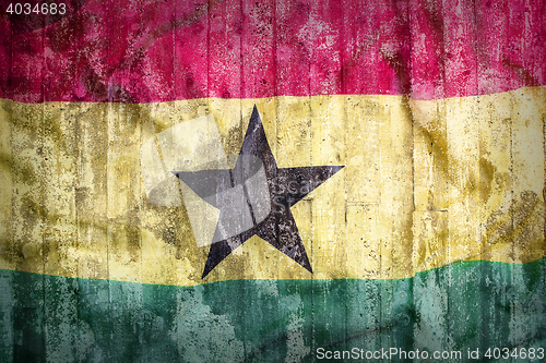 Image of Grunge style of Ghana flag on a brick wall