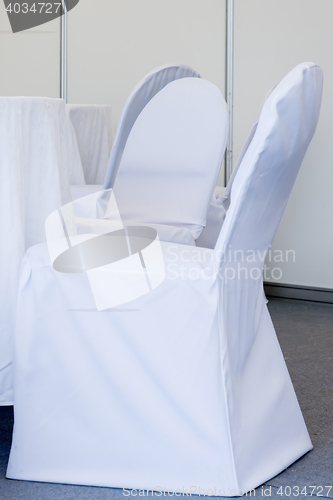 Image of chairs with white fabric cover for celebrations