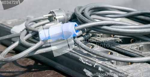 Image of blue electric plug on black cable