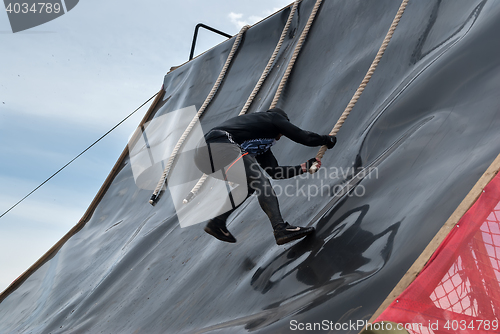 Image of Sportsman storms big wall in extrim race. Tyumen