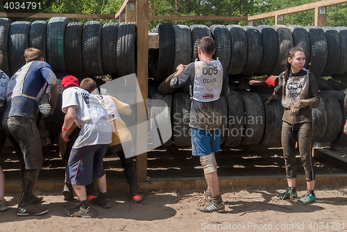 Image of Sportsmen move between old tires. Tyumen