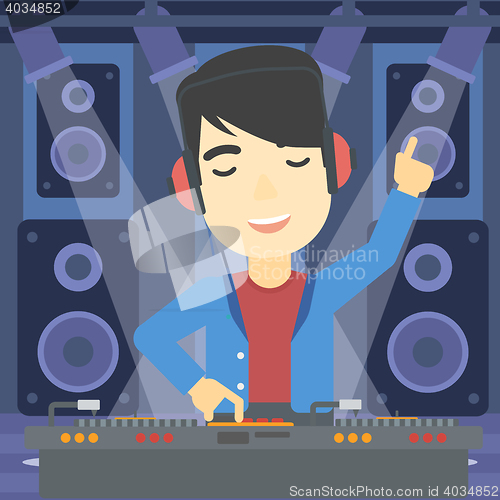 Image of Smiling DJ mixing music on turntables.