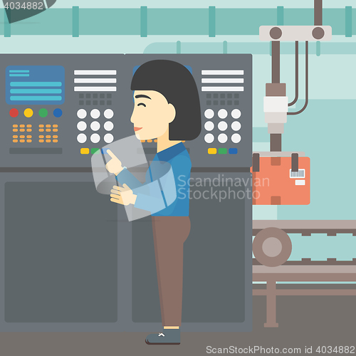 Image of Engineer standing near control panel.
