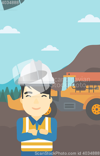 Image of Miner with mining equipment on background.