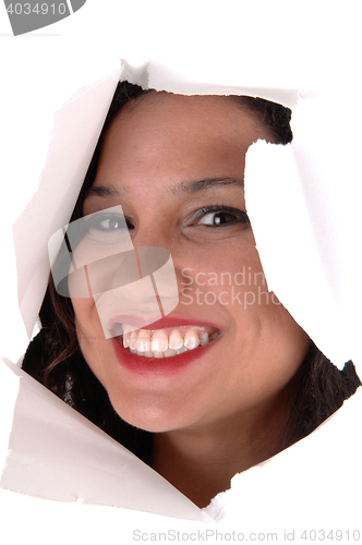 Image of Woman looking through hole in paper.