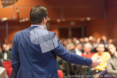 Image of Public speaker giving talk at Business Event.