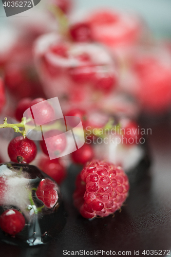 Image of Frozen berries on wooden table