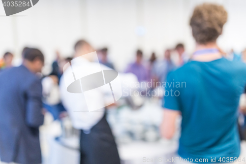 Image of Abstract blurred people socializing during coffee break at business conference.