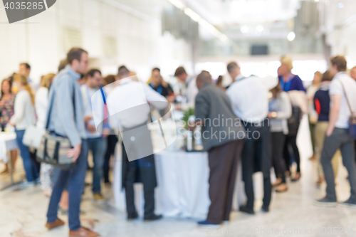 Image of Abstract blurred people socializing during coffee break at business conference.