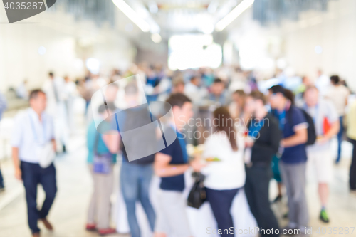 Image of Abstract blurred people socializing during lunch break at business conference.