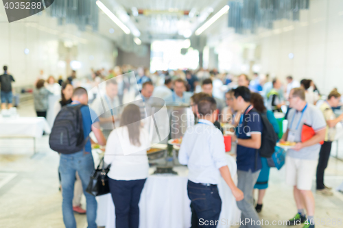 Image of Abstract blurred people socializing during lunch break at business conference.