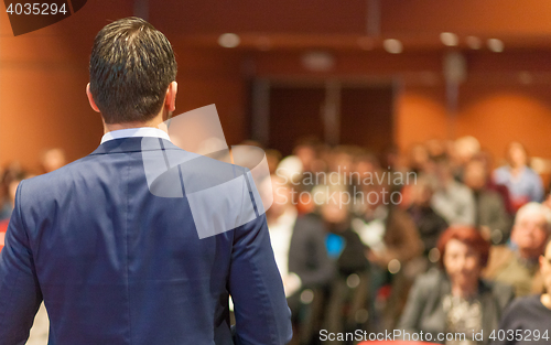 Image of Public speaker giving talk at Business Event.